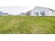 Lush green backyard with grill, offering plenty of space for outdoor activities and relaxation at 238 Switchgrass Ln, New Whiteland, IN 46184