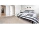 Neutral bedroom with a view into the walk-in closet and an inviting bed at 238 Switchgrass Ln, New Whiteland, IN 46184