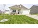 Charming single Gathering home features a two car garage, covered porch, and well maintained lawn at 238 Switchgrass Ln, New Whiteland, IN 46184