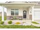 Charming front porch featuring classic columns, seating, and tidy landscaping at 238 Switchgrass Ln, New Whiteland, IN 46184