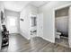 This hallway has doors to a bathroom and bedroom, and features modern grey walls and wood-look floors at 238 Switchgrass Ln, New Whiteland, IN 46184