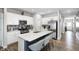 Modern kitchen featuring an island with seating, stainless steel appliances, white cabinetry, and backsplash at 238 Switchgrass Ln, New Whiteland, IN 46184