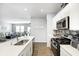 Contemporary kitchen with granite countertops, stainless steel appliances, and views of the living room at 238 Switchgrass Ln, New Whiteland, IN 46184