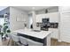 Bright kitchen features a large island with seating, stainless steel appliances, and white cabinetry at 238 Switchgrass Ln, New Whiteland, IN 46184