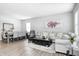 Inviting open-concept living room area with comfortable sofas, modern decor, and wood flooring at 238 Switchgrass Ln, New Whiteland, IN 46184