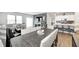 An open-concept living space with a dining area, living room, and kitchen, all with stylish modern decor at 238 Switchgrass Ln, New Whiteland, IN 46184