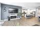 This living space includes an electric fireplace, mounted TV, and flows into a well-appointed kitchen at 238 Switchgrass Ln, New Whiteland, IN 46184