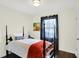 Charming bedroom features hardwood floors and a four-poster bed with orange accents at 2404 Wildwood Ave, Anderson, IN 46011