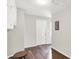 Hallway with laminate floors, gray walls, and white doors leading to other rooms at 2404 Wildwood Ave, Anderson, IN 46011