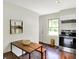 Eat-in kitchen featuring stainless steel appliances, a wooden table with seating, and ample lighting at 2404 Wildwood Ave, Anderson, IN 46011