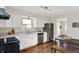 Well-lit kitchen features stainless steel appliances, laminate countertops, and white cabinets at 2404 Wildwood Ave, Anderson, IN 46011
