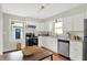 Bright kitchen with stainless steel appliances, a window above the sink, and white cabinetry at 2404 Wildwood Ave, Anderson, IN 46011