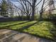 Lush green backyard with mature trees, creating a peaceful and private outdoor space at 2465 N Eaton Ave, Indianapolis, IN 46219