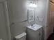 Stylish bathroom with white vanity, mirror, and modern lighting fixtures at 2465 N Eaton Ave, Indianapolis, IN 46219