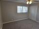 Cozy bedroom features neutral walls, soft carpet, and closet for ample storage at 2465 N Eaton Ave, Indianapolis, IN 46219
