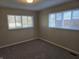 Bright bedroom with natural light from two windows and soft carpet flooring at 2465 N Eaton Ave, Indianapolis, IN 46219