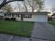 Charming ranch-style home with a well-maintained lawn and attached one car garage at 2465 N Eaton Ave, Indianapolis, IN 46219