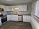 Bright kitchen features stainless appliances, granite counters, and abundant white cabinetry at 2465 N Eaton Ave, Indianapolis, IN 46219