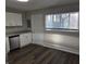 Bright view of the updated kitchen featuring granite countertops and stainless dishwasher at 2465 N Eaton Ave, Indianapolis, IN 46219
