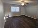 View of the freshly painted living room with new wood-look flooring and ceiling fan at 2465 N Eaton Ave, Indianapolis, IN 46219