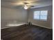 Freshly painted Living room features modern ceiling fan and updated wood-look flooring at 2465 N Eaton Ave, Indianapolis, IN 46219