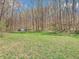 A large grassy backyard features a small storage shed and mature trees at 257 N Letterman Rd, Paragon, IN 46166