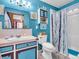Bright bathroom features blue walls, nautical decor, and shower with black and white curtains at 257 N Letterman Rd, Paragon, IN 46166