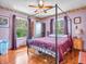 Comfortable bedroom with canopy bed, hardwood floors, and large windows offering scenic views at 257 N Letterman Rd, Paragon, IN 46166