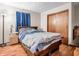 Bedroom includes hardwood floors, large windows, and a cozy bed with patterned bedding at 257 N Letterman Rd, Paragon, IN 46166