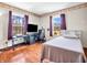 Cozy bedroom with hardwood floors, a single bed, and two windows providing natural light at 257 N Letterman Rd, Paragon, IN 46166