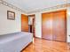 Neutral bedroom features hardwood floors, a double door closet, and soft natural light at 257 N Letterman Rd, Paragon, IN 46166