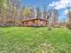Exterior view of a charming brick home set on a lush green lawn with mature trees at 257 N Letterman Rd, Paragon, IN 46166
