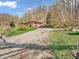 Home exterior with brick, long driveway, and lots of surrounding trees at 257 N Letterman Rd, Paragon, IN 46166