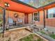 Inviting covered brick porch with seating area and charming decor details at 257 N Letterman Rd, Paragon, IN 46166