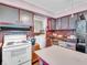 Spacious kitchen featuring a vintage stove and oven, brick-style walls, and plentiful storage options at 257 N Letterman Rd, Paragon, IN 46166