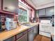 Charming kitchen featuring stainless steel sink, brick backsplash, and plenty of counter space, perfect for cooking and entertaining at 257 N Letterman Rd, Paragon, IN 46166