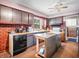Functional kitchen with exposed brick accents, a central island, and ample cabinet space at 257 N Letterman Rd, Paragon, IN 46166