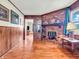 Cozy living room featuring hardwood floors, a brick fireplace, and wood paneling at 257 N Letterman Rd, Paragon, IN 46166
