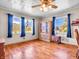 Bright living room featuring hardwood floors, a curio cabinet, and two windows with a great view at 257 N Letterman Rd, Paragon, IN 46166