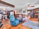 Cozy living room featuring wood paneling, a brick fireplace, and comfortable seating, showcasing a warm and inviting atmosphere at 257 N Letterman Rd, Paragon, IN 46166