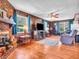 Comfortable living room featuring hardwood floors, brick fireplace, and wood paneling at 257 N Letterman Rd, Paragon, IN 46166