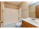 Bathroom featuring a shower and tub, a toilet, a large mirror, a sink, and wooden cabinets at 2680 Woodfield Blvd, Franklin, IN 46131