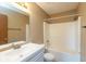 Bathroom featuring a shower and tub, a toilet, a large mirror, a sink, and white cabinets at 2680 Woodfield Blvd, Franklin, IN 46131