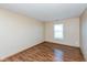 Bedroom featuring laminated floors, neutral walls, a window to let in natural light, and an electric outlet at 2680 Woodfield Blvd, Franklin, IN 46131