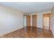 Bedroom featuring laminated floors, neutral walls, and three wooden doors leading to other areas in the home at 2680 Woodfield Blvd, Franklin, IN 46131