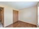 Bedroom featuring laminated floors, neutral walls, an electric outlet, and a closet with wooden doors at 2680 Woodfield Blvd, Franklin, IN 46131