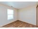 Bedroom featuring laminated floors, neutral walls, a window to let in natural light, and an electric outlet at 2680 Woodfield Blvd, Franklin, IN 46131