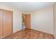 Bedroom featuring laminated floors, neutral walls, and three wooden doors leading to other areas in the home at 2680 Woodfield Blvd, Franklin, IN 46131