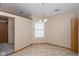Bright dining area features neutral tones, tile floors, and an elegant chandelier above the dining space at 2680 Woodfield Blvd, Franklin, IN 46131