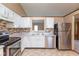 Well-equipped kitchen with stainless steel appliances, tile backsplash, and granite countertops at 2680 Woodfield Blvd, Franklin, IN 46131